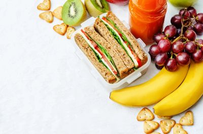 Healthy lunch with a sandwich, fresh fruits, and juice.