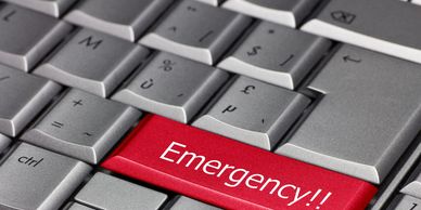 computer keyboard showing Emergency key