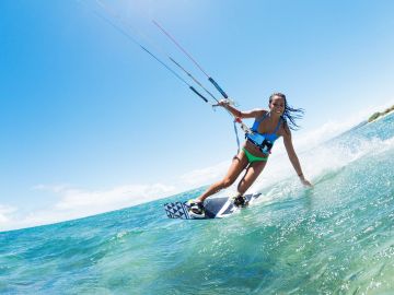 Woman kiteboarding on a sunny day.