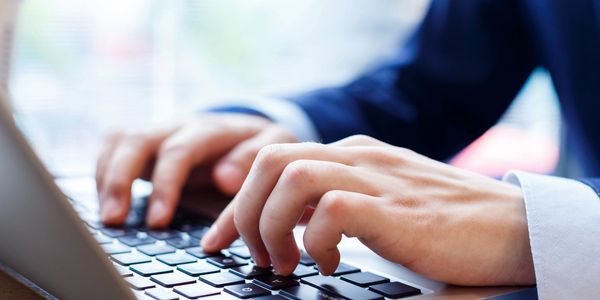 Student typing on a laptop.