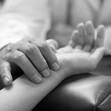 A person checking another person's pulse on their wrist.