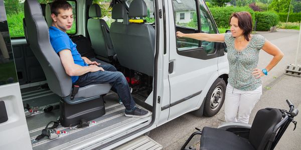 man in car with wheelchair