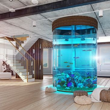Modern living room with a large cylindrical aquarium as a centerpiece.