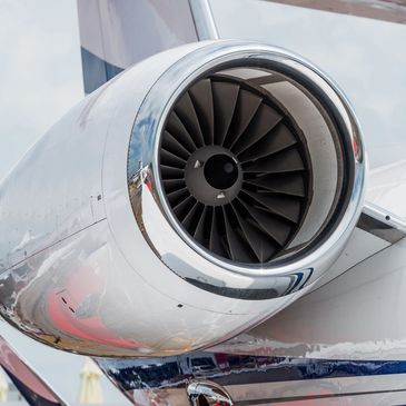 Close-up of a jet engine on an aircraft wing.