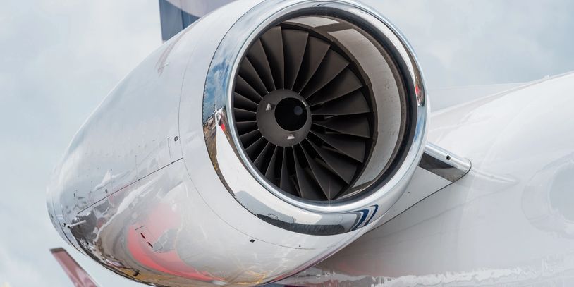 Close-up of a jet engine turbine on an airplane wing.
