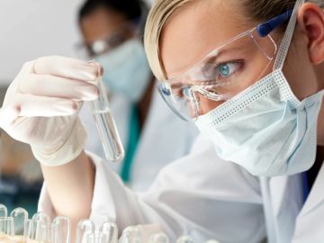 Scientist examining test tube in lab.