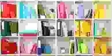 Different coloured ringbinders and stationery displayed tidily in a bookcase.