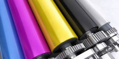 Ink rollers showing cyan, magenta, yellow, black and white ink.