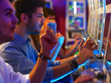 People playing slot machines in a casino.