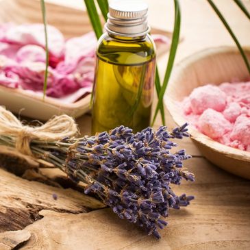 Natural skincare ingredients candles and lavender on table