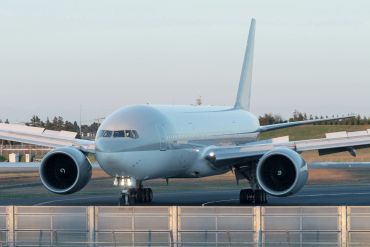 A large commercial airplane on the runway preparing for takeoff.