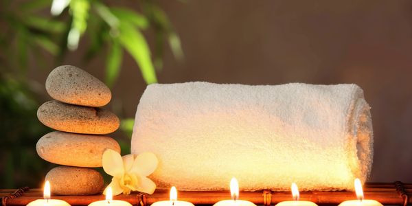 white towel, rocks and tea lights