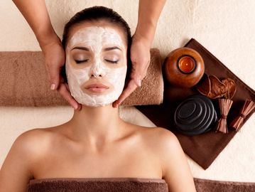 Young woman receiving a refreshing facial treatment in Las Vegas day spa. Ageless Massage Facial.