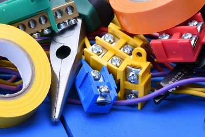 Electrical tools, wires, and connectors on a blue surface.