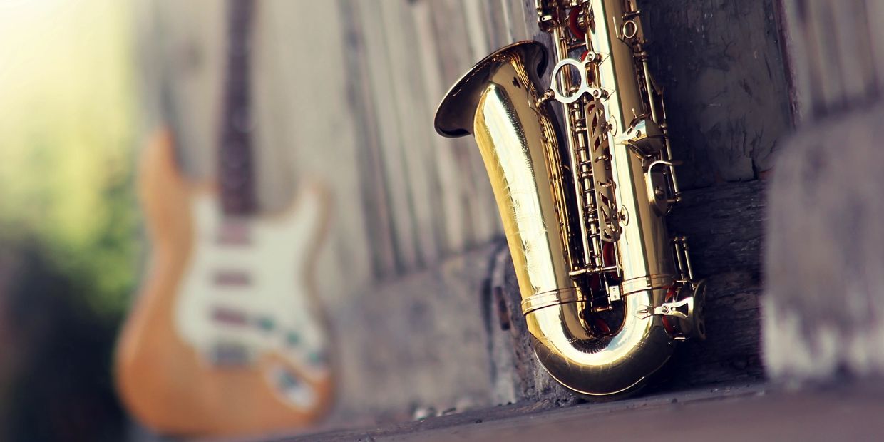 A saxophone next to a bass outside