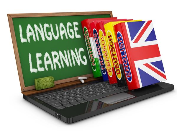 Laptop with language books and a chalkboard saying 'Language Learning'.