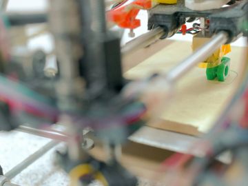 Close-up of a 3D printer in action creating an object.