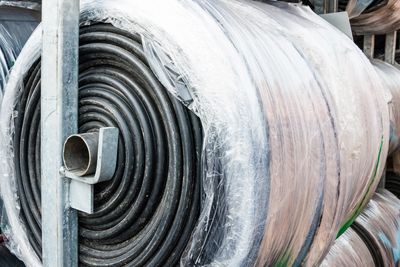 Roll of conveyor belting on a metal rack 