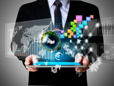 Businessman holding tablet with digital financial and global icons.