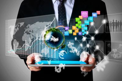 Businessman holding a tablet with digital financial and global icons.