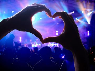 Photo of two hands coming together to make the shape of a heart