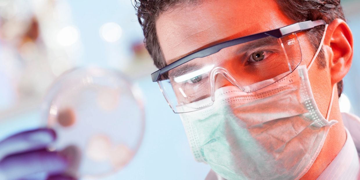 Lab technician examining plating results to verify product quality and regulatory compliance.