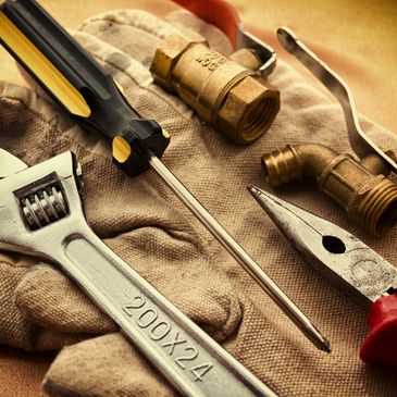 handyman's tools laid out on top of a glove