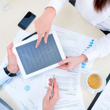 Two people at a table looking at school data.