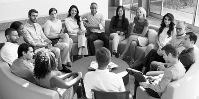 Group discussion amongst workers in an office setting.