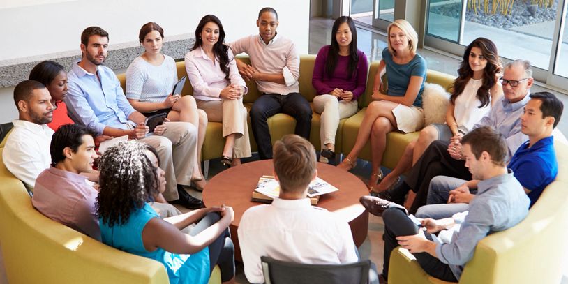 Diverse group of employees sitting around a table