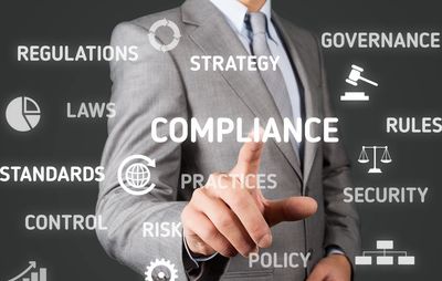 Image of business person with Audit terms  and symbols in the foreground