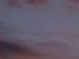 A serene dusk sky with soft purple and pink hues.