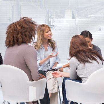 Young women and men in communications discuss an online media planning project.