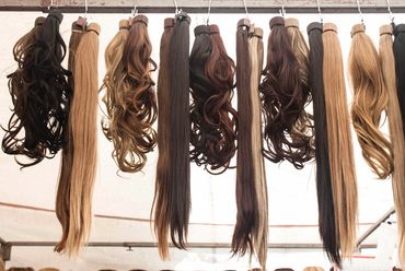Various hair extensions hanging on display.
