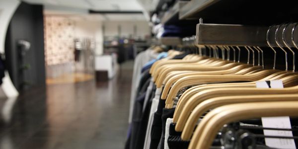 clothes hanging on racks in a store