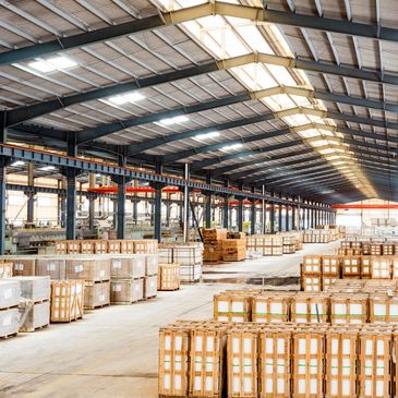 Large warehouse with wooden crates and pallets.