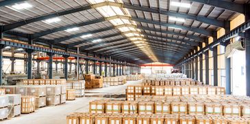Large warehouse filled with stacked wooden crates and boxes.