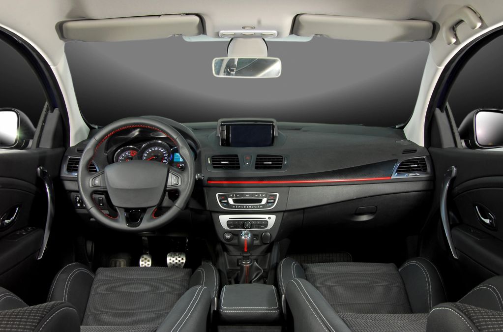 Modern car interior with steering wheel and dashboard.