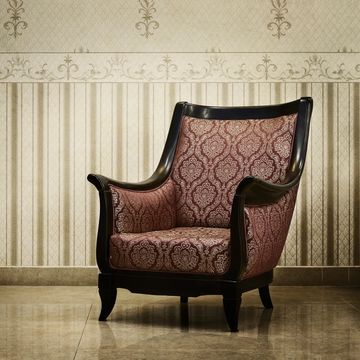 Elegant vintage armchair with patterned upholstery and dark wooden frame.