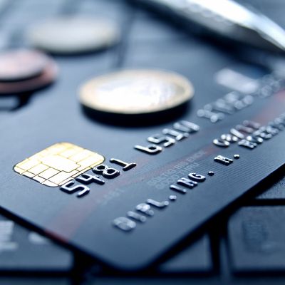 Close-up of a credit card with embossed numbers and a chip.