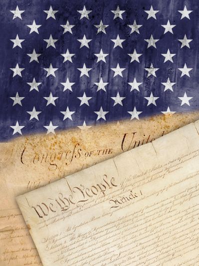 The U.S. Constitution under a faded American flag background.