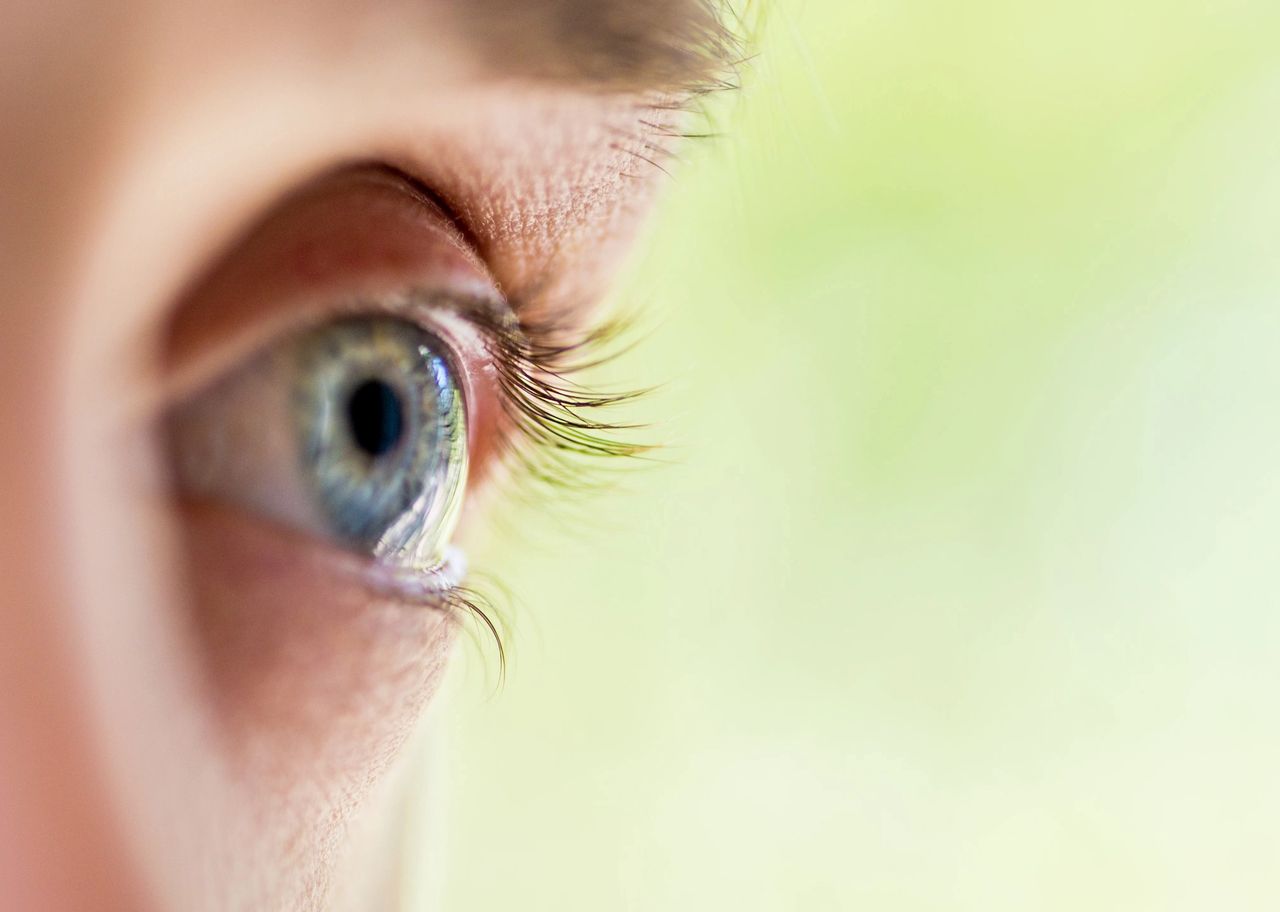 Close-up of a person's eye as they loom ahead.