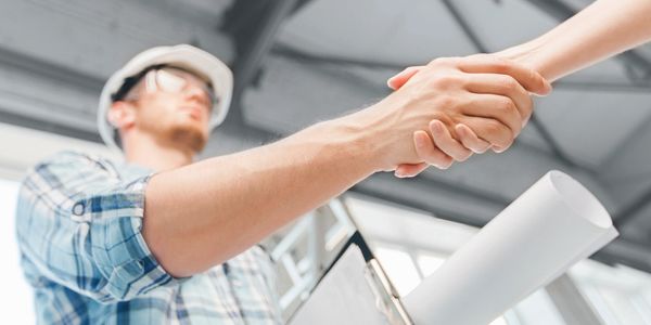 People conducting business shaking hands