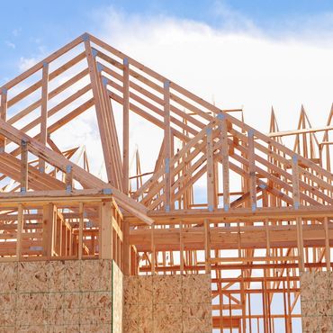 Wood construction housing in framing phase of building.