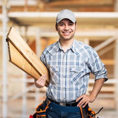 Image of person with wood boards under their arm.