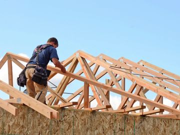man and roof trusses