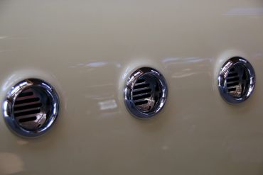 Close-up of three circular chrome air vents.