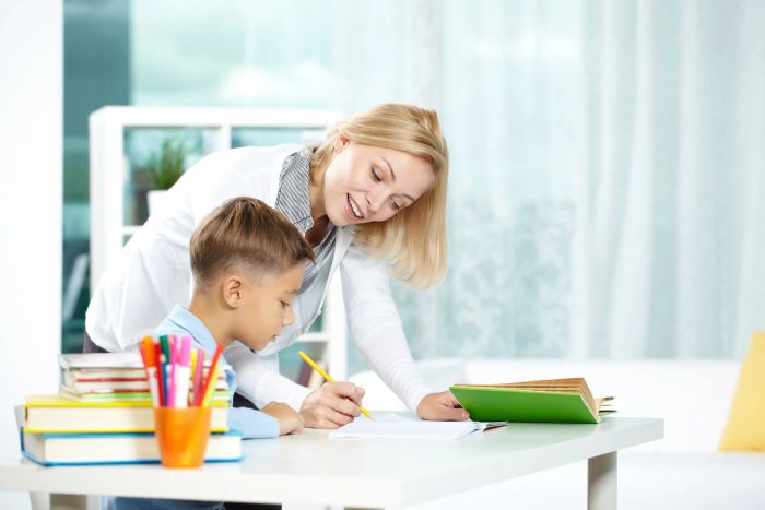 Tutor helping a child with his homework