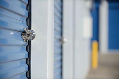 self storage lockers
round lock on storage locker door
blue metal roll up door
