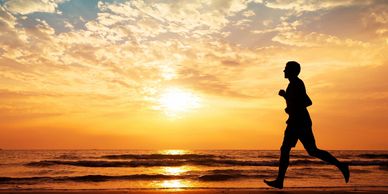 healthy active person running on beach